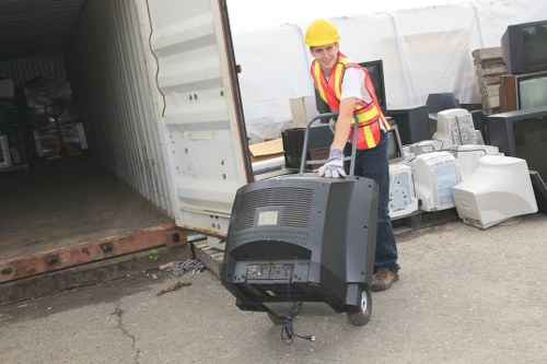Workers using mechanical aids during garden waste removal